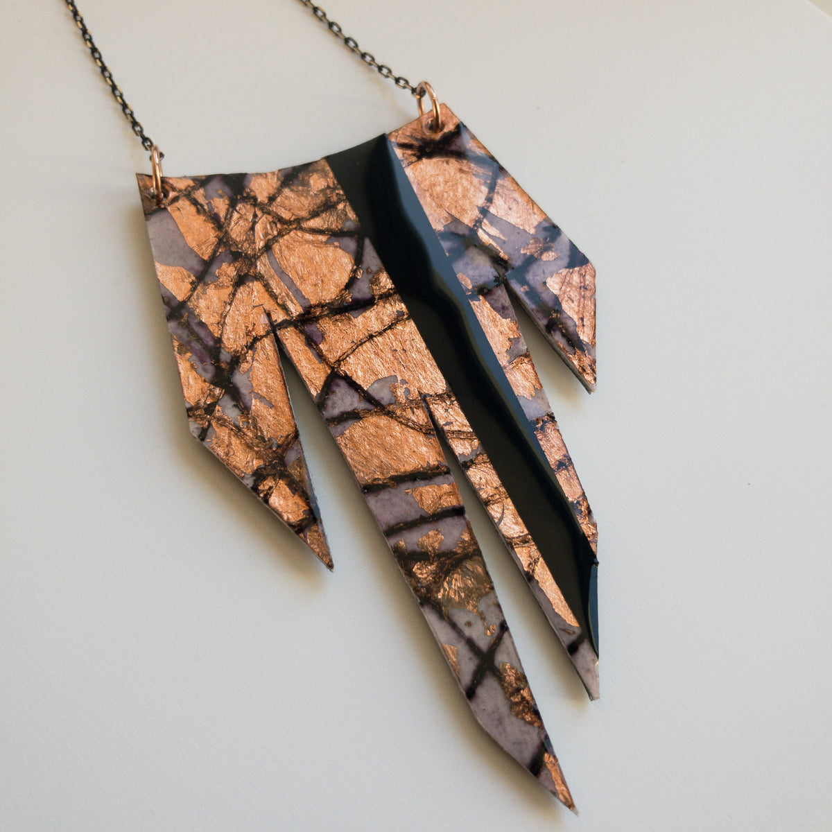 Sybby batik textile necklace in aubergine/rose-gold with black stripe detail